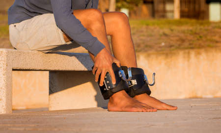 Man putting on anti gravity or inversion boots for upside down hanging. Sports equipment.の写真素材
