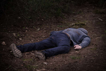 A caucasian mans dead body was found in the park. Murder in the woods. Murdered citizen. Crime scene