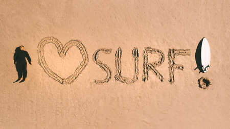 I love surf. Top view of a surfer with a surfboard lying on the sand on the beach. Water sports. Surfingの写真素材