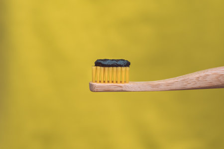 Eco friendly natural bamboo toothbrush with black charcoal whitening toothpasteの写真素材