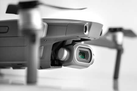 Close up of new dark grey drone isolated on gray backgroundの写真素材