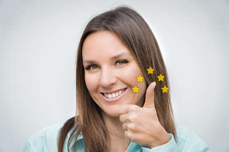 Happy smiling woman client showing thumb up. Quality status is five stars. Great customer...