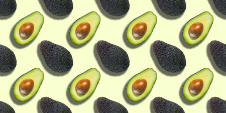 Seamless pattern of fresh ripe green avocado isolated on green background. Top view. Banner. Flat...