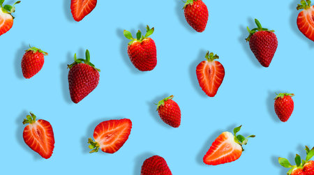 Different ripe strawberries and strawberry slices isolated on blue background. Banner.の写真素材