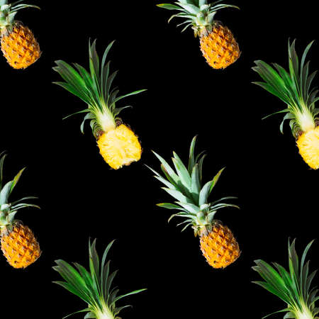 Seamless pattern of ripe pineapples isolated on black background. Top view. Exotic tropical fruit...
