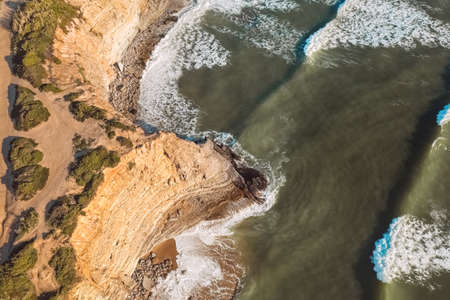 Aerial drone view of beautiful Atlantic ocean coastline and cliff in Praia de Ribeira dIlhas in Ericeira, Portugalの写真素材