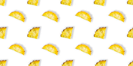 Seamless pattern of fresh ripe pineapple slices isolated on white background. Top view. Exotic tropical fruitの写真素材