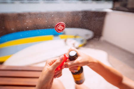 Opening bottle of super bock beer with exploding and splashing. Focus on the cap. 31.03.2021, Costa Da Caparica, Portugalのeditorial素材
