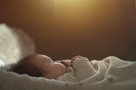 Cute baby in white clothes sleeping in bed. Adorable kid portrait. 3 month old childの写真素材