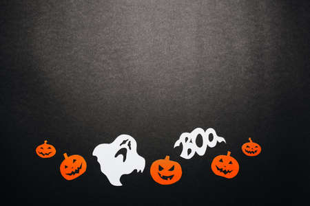 Happy halloween holiday concept. Bats, pumpkins and ghosts on black backgroundの写真素材