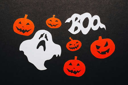 Happy halloween holiday concept. Bats, pumpkins and ghosts on black background