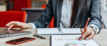 Business woman checks charts and refreshes financial progress. The girl analyzes the business model...