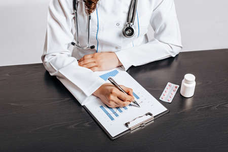Doctor Writing Medical Pill Prescription for Patientの写真素材