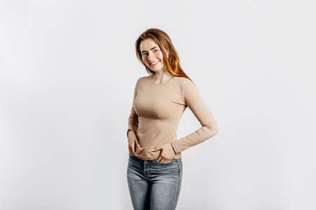 Beautiful young girl smiling and posing looking at the camera on a white isolated background. Positive brunette woman. Kind look. Beauty face.の写真素材