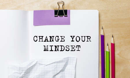 CHANGE YOUR MINDSET text written on a paper with pencils on the desk in the officeの写真素材
