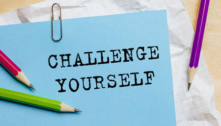 CHALLENGE YOURSELF text written on a paper with pencils in officeの写真素材
