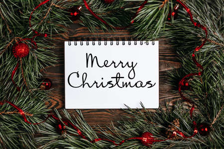 Merry christmas and merry new year concept with gift boxes, toys and notebook with text Merry Christmasの写真素材