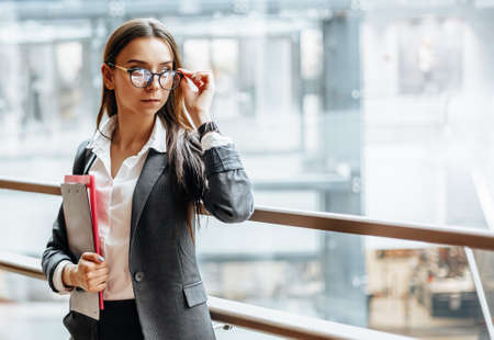 Businesswoman with documents for work. Student girl with folders with documentation. An officer will collect information.の写真素材