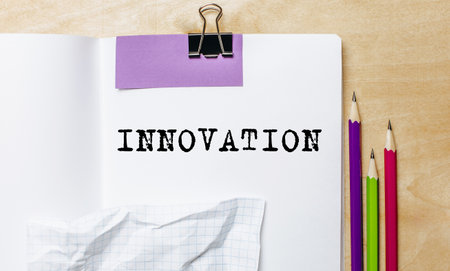 INNOVATION text written on a paper with pencils on the desk in the officeの写真素材