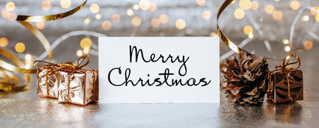 Merry christmas and merry new year concept with gift boxes and greeting card with text Merry Christmasの写真素材