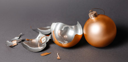 Broken christmas toy to decorate the new year holidays on a dark gray backgroundの写真素材