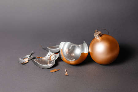 Broken christmas toy to decorate the new year holidays on a dark gray background