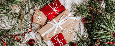 New year gifts on knitted background with christmas tree and toys