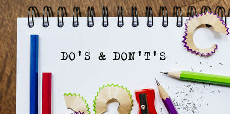 Do's and Don't's text written on a paper with pencils in officeの写真素材