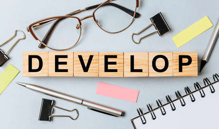 DEVELOP word on wooden cubes on office deskの写真素材