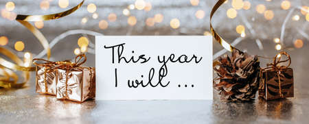 Merry christmas and merry new year concept with gift boxes and greeting card with text This year I will ...の写真素材