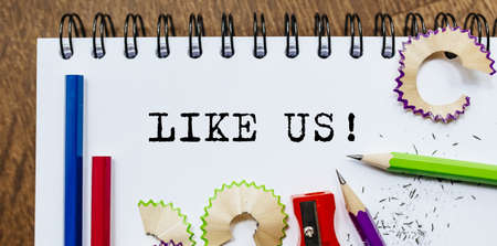 Like us text written on a paper with pencils in officeの写真素材