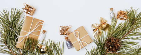 New year golden gifts for merry christmas with fir branches on white backgroundの写真素材