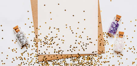 Blank note with envelope, gifts and gold glitter stars on white backgroundの写真素材