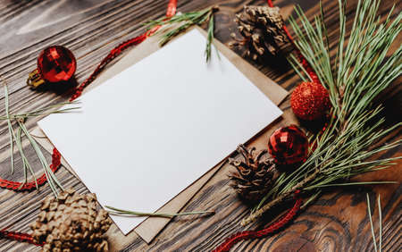 Blank note with fir branch and Christmas toys on wooden background. New Year conceptの写真素材