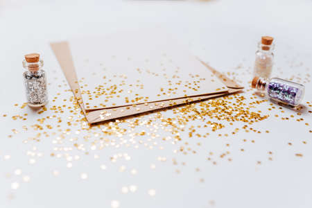 Blank note with envelope, gifts and gold glitter stars on white backgroundの写真素材