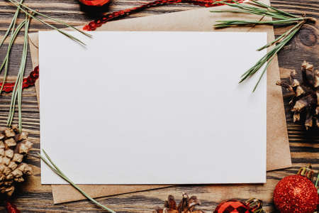 Blank note with fir branch and Christmas toys on wooden background. New Year conceptの写真素材