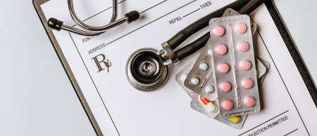 Medical concept with stethoscope, pills, notepad, pen on the doctor desktopの写真素材