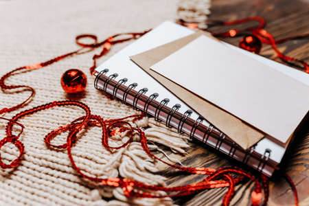 Blank note on wooden and knitted background. Merry christmas and new year conceptの写真素材