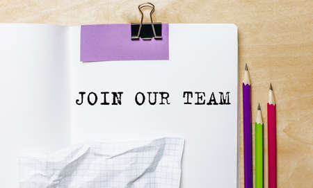 JOIN OUR TEAM text written on a paper with pencils on the desk in the officeの写真素材