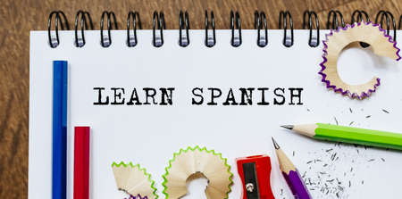 Learn Spanish text written on a paper with pencils in officeの写真素材