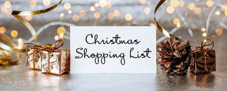 Merry christmas and merry new year concept with gift boxes and greeting card with text Christmas Shopping Listの写真素材