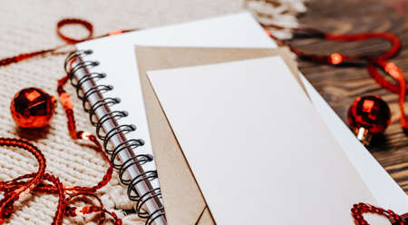 Blank note on wooden and knitted background. Merry christmas and new year concept