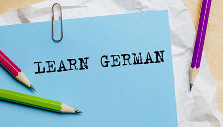 Learn German text written on a paper with pencils in officeの写真素材
