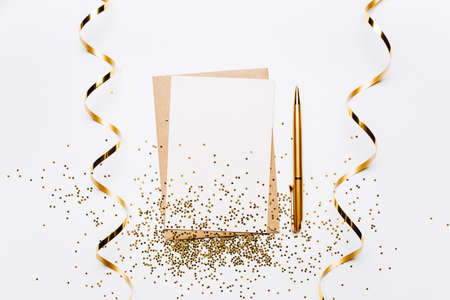 Blank note with envelope, ribbon, confetti, pen and gold glitter stars on white background