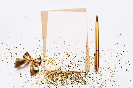 Blank note with envelope, pen and gold glitter stars on white backgroundの写真素材