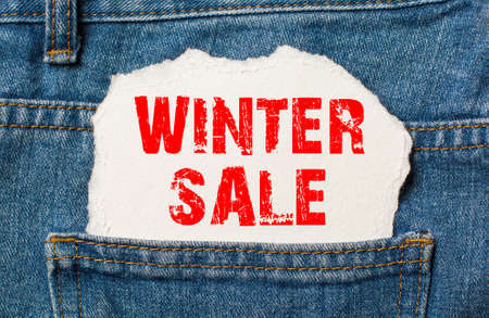 winter sale on white paper in the pocket of blue denim jeansの写真素材