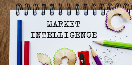 Market Intelligence text written on a paper with pencils in officeの写真素材