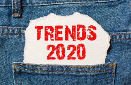 Trends 2020 on white paper in the pocket of blue denim jeansの写真素材