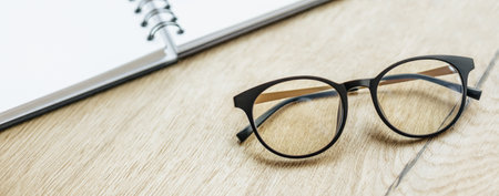 Glasses at the workplace in the office near the notepad. Business hoursの写真素材