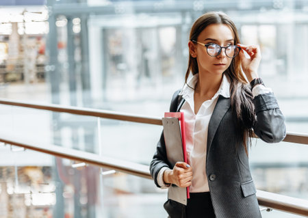 Businesswoman with documents for work. Student girl with folders with documentation. An officer will collect information.の写真素材